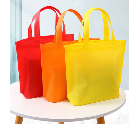 Sacos favoritos de festas não tecidos Sacos coloridos reutilizáveis Sacos não tecidos de cor sólida Sacos reutilizáveis de tote a granel com alças Sacos de mercearia não tecidos reutilizáveis