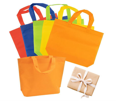 Sacos favoritos de festas não tecidos Sacos coloridos reutilizáveis Sacos não tecidos de cor sólida Sacos reutilizáveis de tote a granel com alças Sacos de mercearia não tecidos reutilizáveis